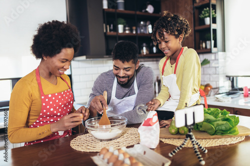 Happy family preparing healthy food in kitchen together