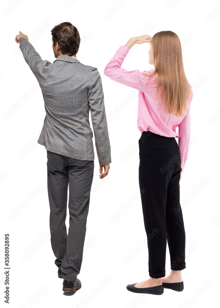 Back view of business man and business woman in suit pointing. Back view of business man and business woman in suit pointing.