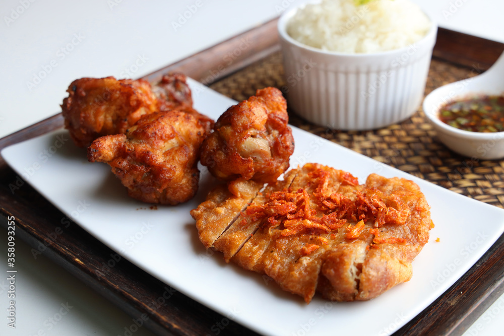 Sticky rice with fried pork served with Jaew Thai dipping sauce, placed on a wooden tray Ready to eat Sticky rice with fried pork served with Jaew Thai dipping sauce, placed on a wooden tray Ready to eat