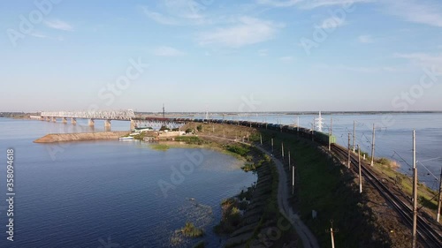 Wallpaper Mural Aerial flying with freight train pulls into a bridge over a river at sunset Torontodigital.ca