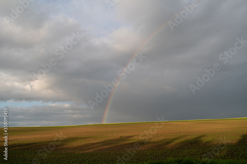 Cloudy sky after the rain. Rainbow. Natural seasonal, weather, climate, countryside beauty concept and background scene. Ecology