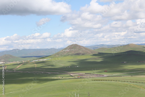 Rocky mountains amid green fields and clear skies