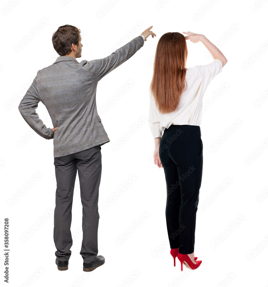 Back view of business man and business woman in suit pointing. Back view of business man and business woman in suit pointing.