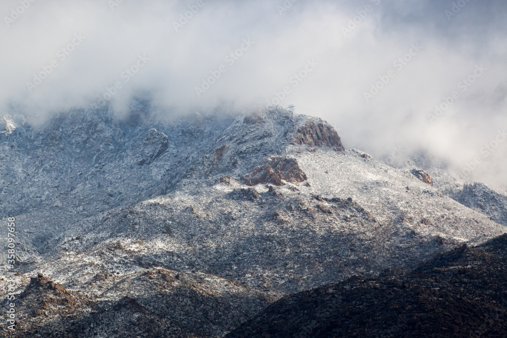 Winter mountain, snow capped and cloud covered Winter mountain, snow capped and cloud covered