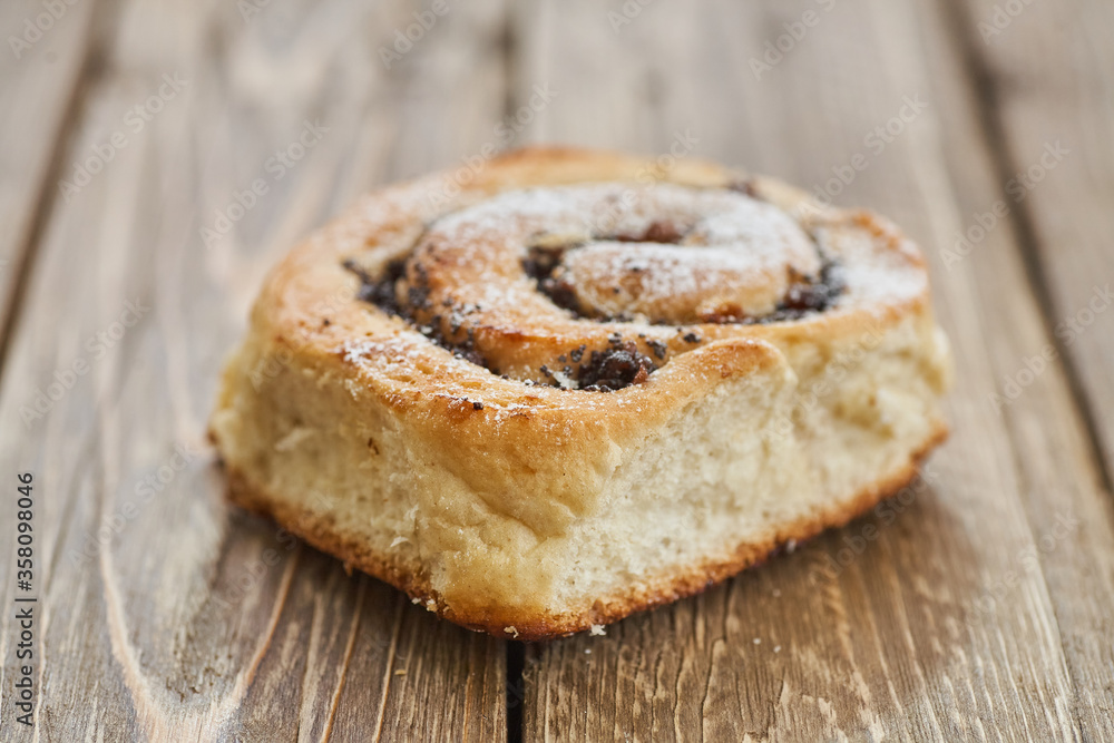 Tasty buns with raisins on a brown rustic wooden table. fresh bakery. breakfast. bread. top view Tasty buns with raisins on a brown rustic wooden table. fresh bakery. breakfast. bread. top view