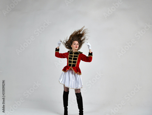 beautiful girl in red hussar uniform with loose hair