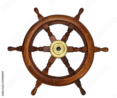 isolated image of wooden wheel made of oak with brass hub and turned handles for steering a ship or boat. photo