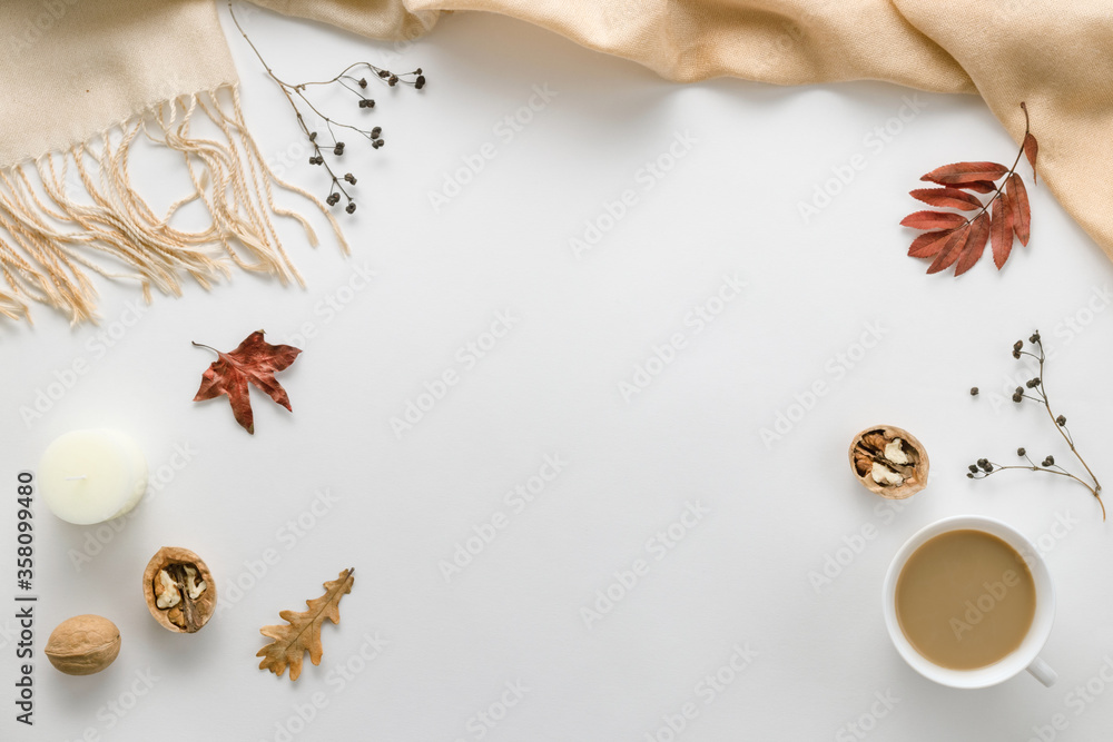 Autumn composition. Cup of coffee, plaid, candle, dried leaves on a white background. Autumnal, flat lounger, top view. Copy space
