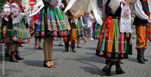 Local people in traditional folk costumes from Lowicz in Poland while join annual Corpus Christi procession in street