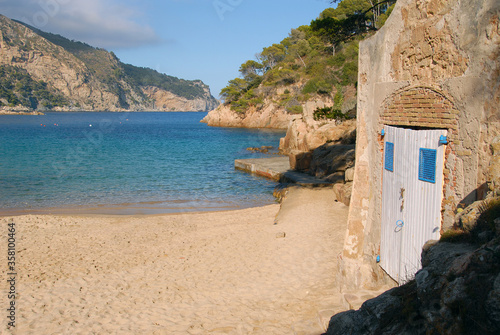 Altes Bootshaus am leeren Strand in Sa Riera photo