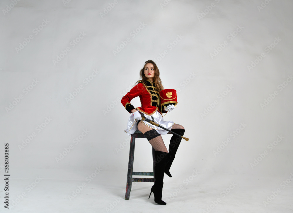 beautiful girl in red hussar uniform with loose hair beautiful girl in red hussar uniform with loose hair