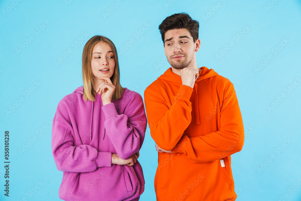 Thinking cunning loving couple looking at each other. Thinking cunning loving couple looking at each other.