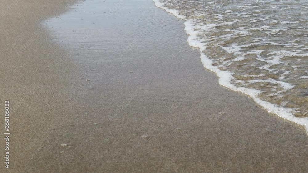 Soft ocean wave on sandy tropical beach. Soft ocean wave on sandy tropical beach.