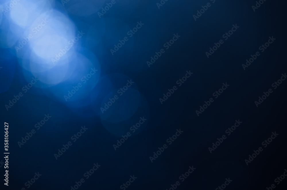 blur background abstract blue color. defocused glittering of glitter beautiful colorful soft effect pattern design for backdrop or wallpaper. The diagonal light shines from the top corner. blur background abstract blue color. defocused glittering of glitter beautiful colorful soft effect pattern design for backdrop or wallpaper. The diagonal light shines from the top corner.