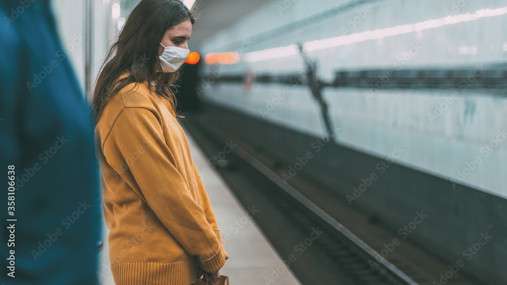 passengers in protective masks standing at the metro station passengers in protective masks standing at the metro station
