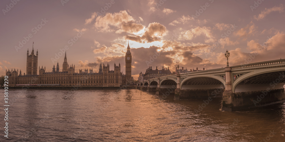 Big Ben and Westminster bridge at intense sunset