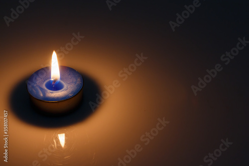 candles burning on the background blue color