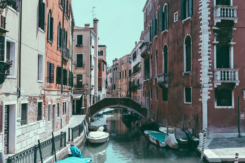 Panoramic view of Venice narrow canal with historical buildings and boats