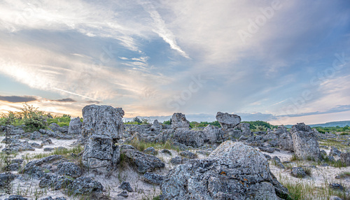 Stone blocks in a sand dune at sunset.