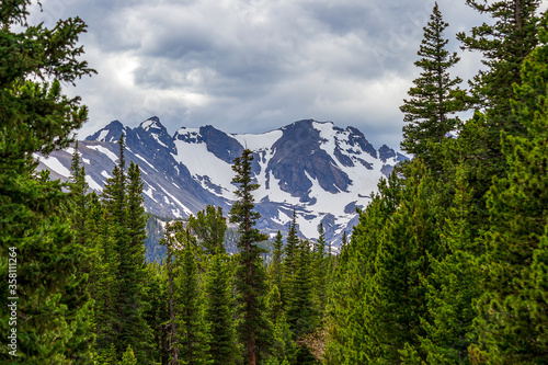 Dramatic forest and Indian Peaks near Red Rock Lake, Nederland, Colorado, on a spring day photo