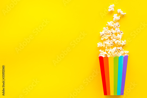Fototapeta Naklejka Na Ścianę i Meble -  Popcorn in rainbow paper cup top-down copy space
