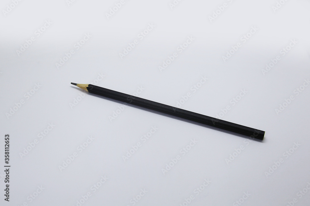 Black pencil, an instrument used to write, draw or doodle is cylindrical and wooden in shape with a graphite on the inside Black pencil, an instrument used to write, draw or doodle is cylindrical and wooden in shape with a graphite on the inside