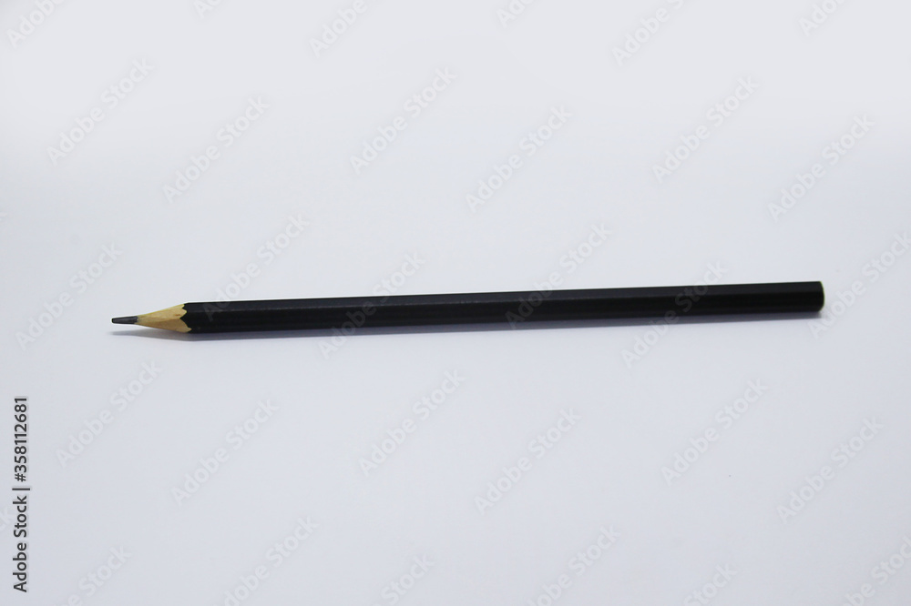 Black pencil, an instrument used to write, draw or doodle is cylindrical and wooden in shape with a graphite on the inside Black pencil, an instrument used to write, draw or doodle is cylindrical and wooden in shape with a graphite on the inside
