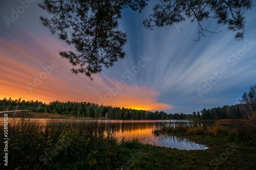 Beautiful sunset over the river and forest