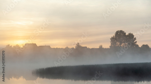 River before sunrise in the fog