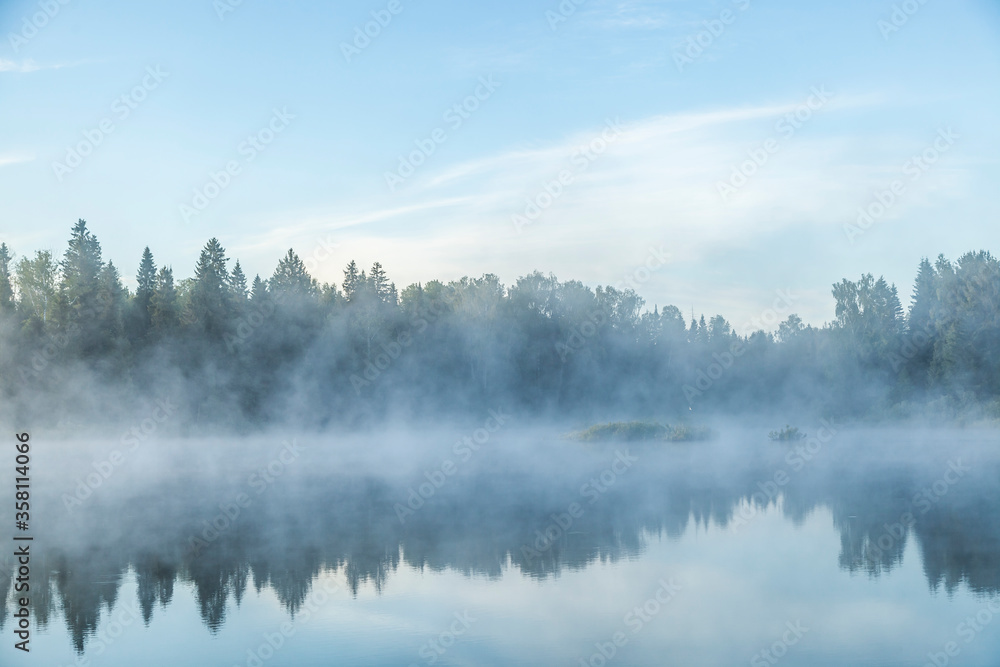 River before sunrise in the fog