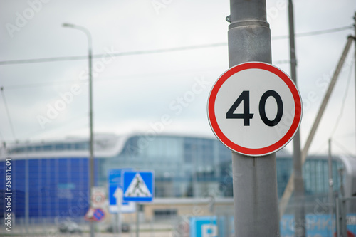 A speed limit sign at 40 kilometers per hour in front of the airport.