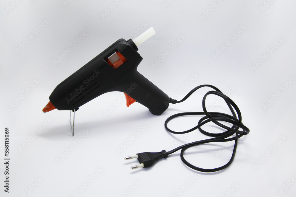 Hot glue gun, an electrical instrument used to apply hot glue to various materials, especially in crafts Hot glue gun, an electrical instrument used to apply hot glue to various materials, especially in crafts