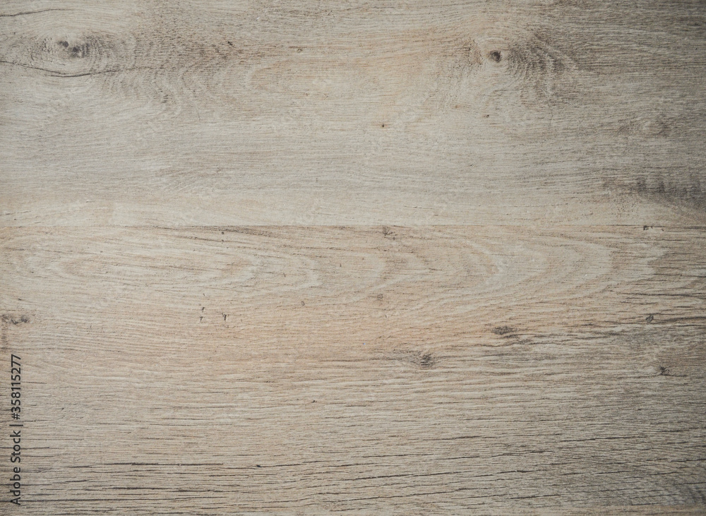 Fototapeta premium Light wooden surface. Beige gray board. Wooden laminate parquet floor texture background. Beautiful decorative background. Wood texture for background. Close-up wooden surface.