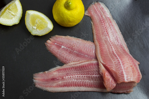 Wallpaper Mural Fresh, unroasted African catfish fillet. Black background Torontodigital.ca