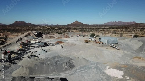 4K aerial drone video of African savanna hills, stone quarry near granite boulders range at B1 highway south of Windhoek in central highland Khomas Hochland of Namibia, southern Africa photo