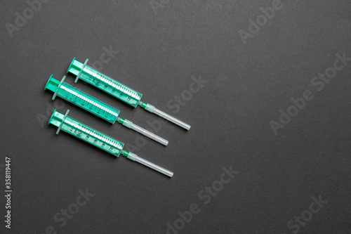 Top view of syringes in a row for medical injection on colorful background with copy space. Health and vaccination concept