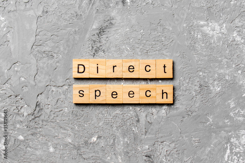direct speech word written on wood block. direct speech text on cement table for your desing, concept