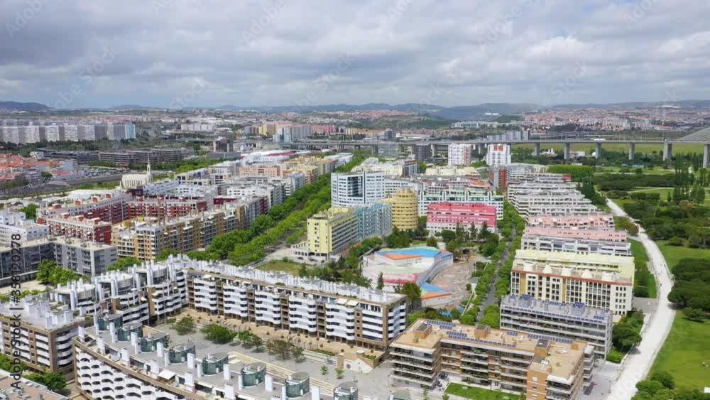 Aerial view overlooking modern buildings in the Park of Nations. on a sunny day, in Lisbon, Portugal - reverse, drone shot Aerial view overlooking modern buildings in the Park of Nations. on a sunny day, in Lisbon, Portugal - reverse, drone shot