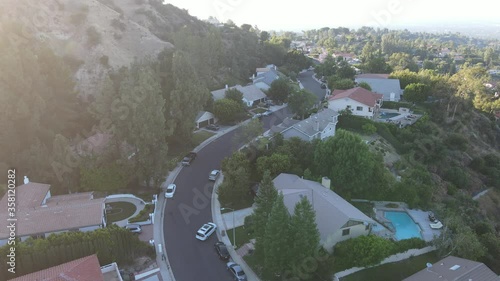 Car entering driveway in suburban Los Angeles neighborhood photo