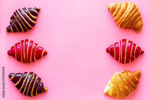 Set of croissants - chocolate, berry, classic - on pink desk top view © 279photo