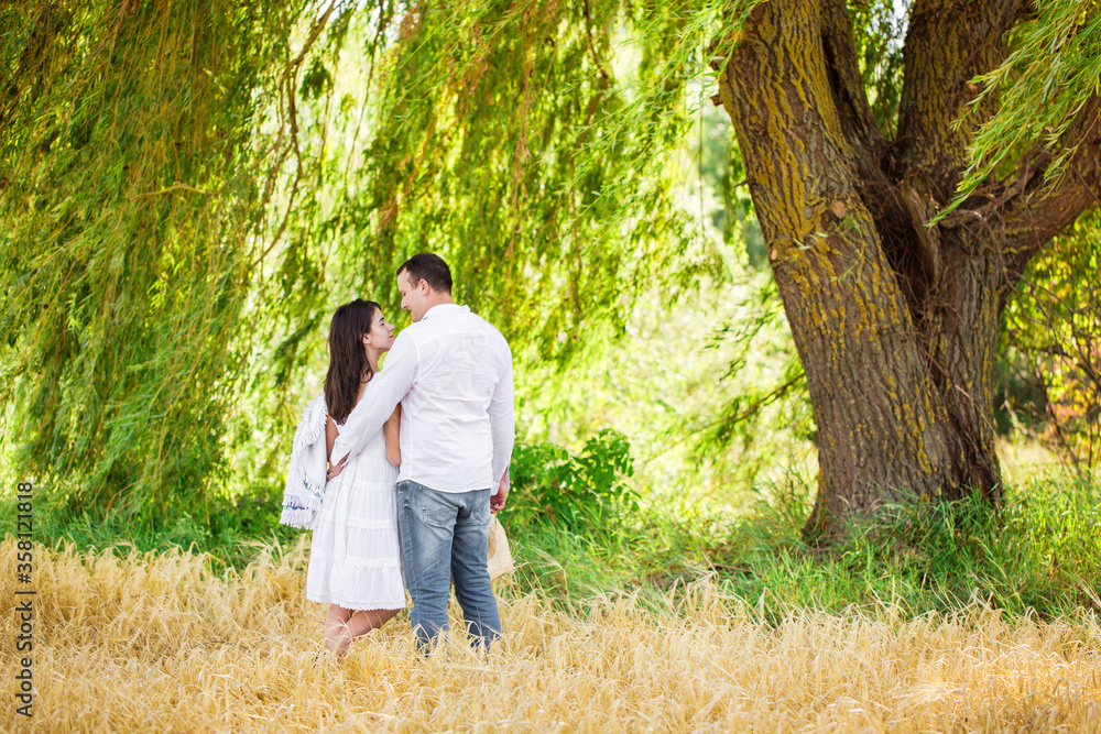 A guy and a girl under a large willow A guy and a girl under a large willow