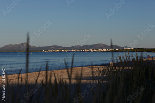 Sunset in the bay of Alcudia. In front the Punta Des Caló, on the right the town of Can Picafort. Mallorca Spain