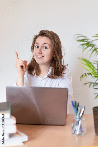 Work from home. Woman drinking coffee and using digital tablet in the morning. Hands on laptop