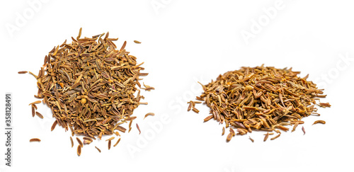 Pile of cumin (cuminum cyminum) seeds isolated on white background. Dry Zira herb and spice for cooking food.