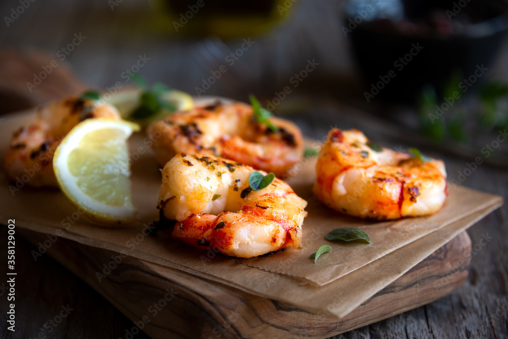 Roasted shrimps with lemon and herbs, healthy seafood meal Roasted shrimps with lemon and herbs, healthy seafood meal
