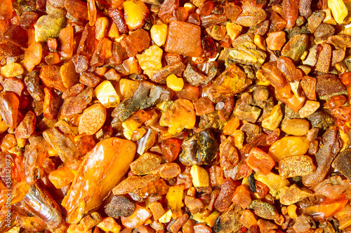 Close up. Background, texture.     Orange, brown and yellow natural, raw amber stones  found on the Polish cost of the  Baltic Sea    photo