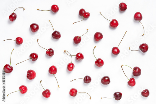 Fresh cherries pattern on white background. Ripe cherry berries, top view.