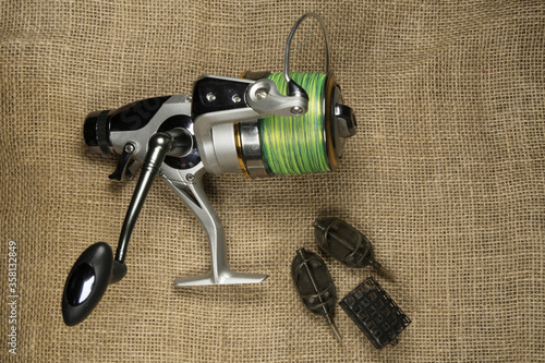 Fishing, carp reel with fishing linel on the background of burlap . Burlap photo