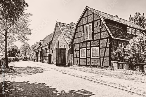 Fototapeta Naklejka Na Ścianę i Meble -  Sepia toned image of historic barns in village Ahlden, Lower Saxony, Germany