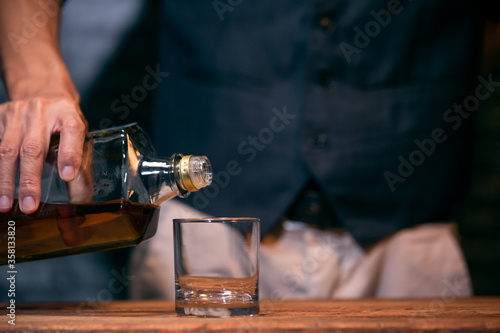 bartender pouring whiskey